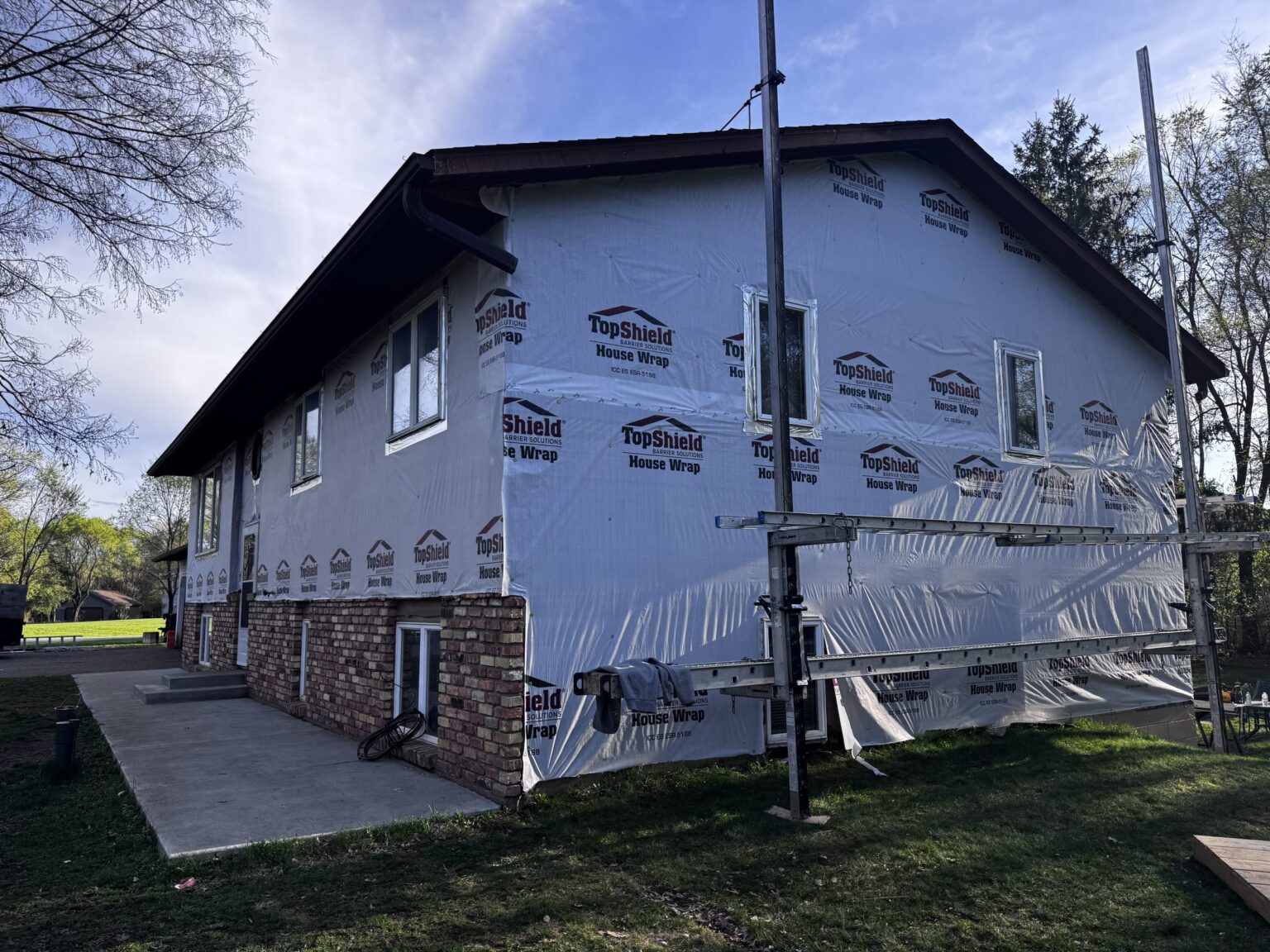 Jacobs Construction house wrap installation project in Ham Lake Minnesota showing blue TopShield wrapping